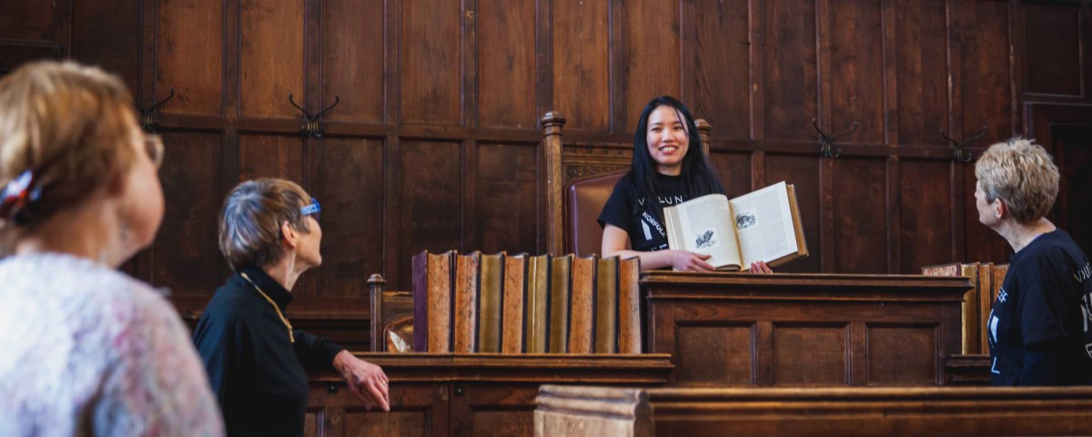 People standing in an old court room in the Guidhall