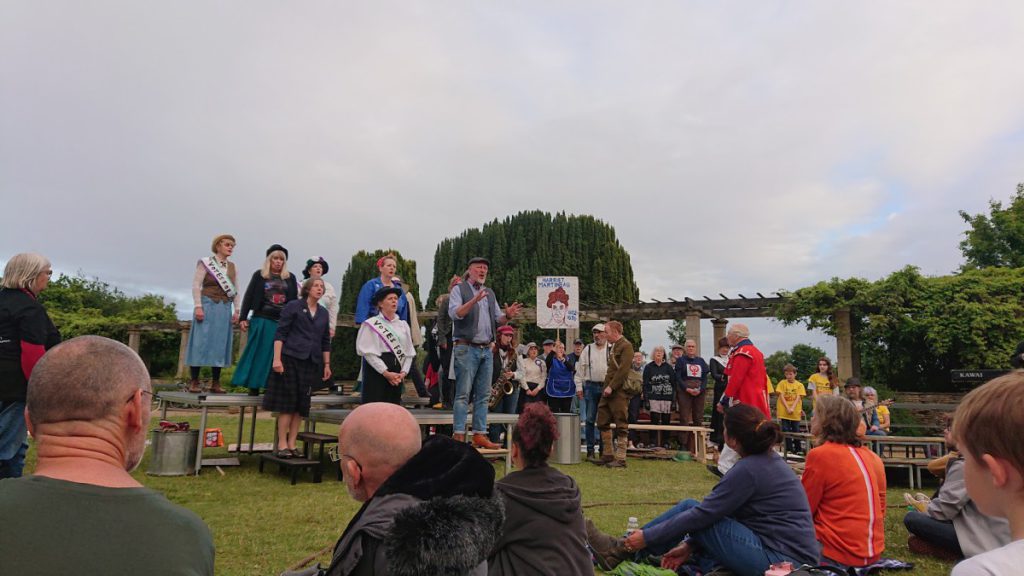 Actors on a stage in a park
