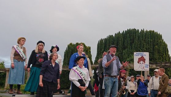 Actors on a stage in a park