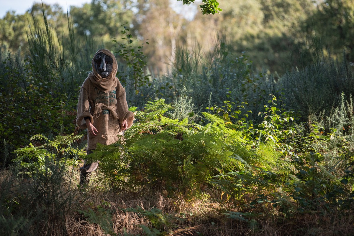 A masked figure stands on Mousehold Heath, Norwich