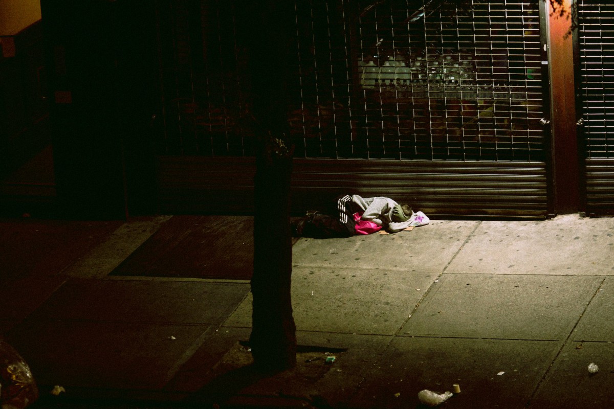 Person sleeping on the floor outside