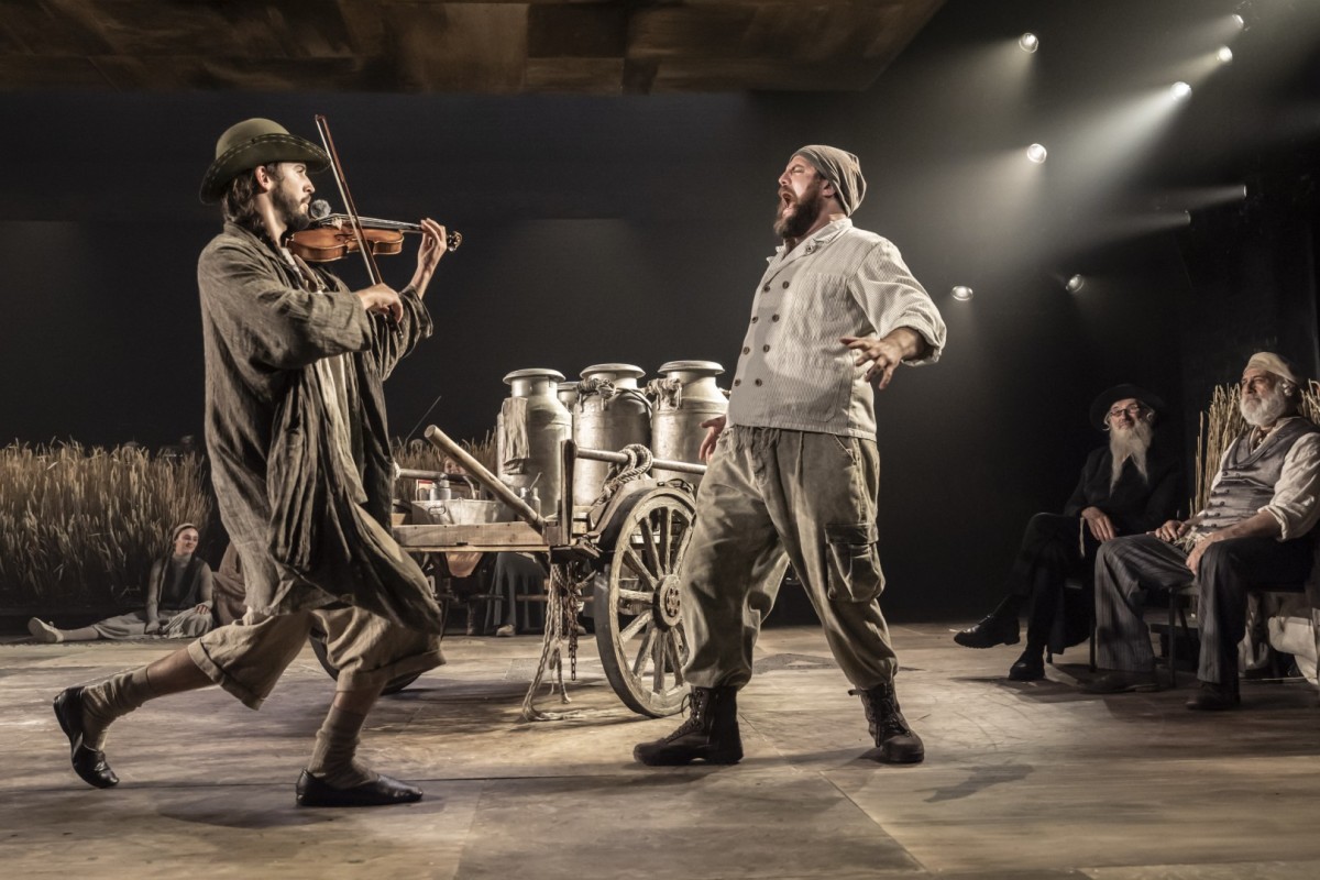 Roman Lytwyniw as The Fiddler and Matthew Woodyatt as Tevye - Photo: Johan Persson