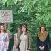 Women in period costume holding protest signs